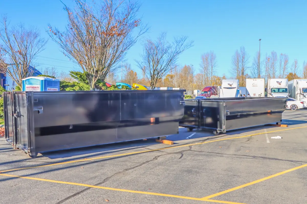 Professional dumpster rental service with roll-off container on residential driveway in East Caln